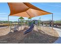 Modern playground with shade structure, slides, and climbing equipment at 44713 N 44Th Dr, Phoenix, AZ 85087