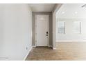 Front entry with white door and light tile floor at 5837 E Ringtail Way, Phoenix, AZ 85054