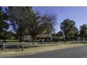 House with white fence and mature trees at 1137 S 131St St, Gilbert, AZ 85233