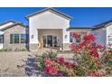 Front view of a modern home with red flowers at 4072 E Weston Ln, San Tan Valley, AZ 85140