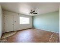 Simple living room with light walls and ceiling fan at 1017 E Diana Ave, Phoenix, AZ 85020