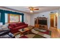 Living room with a red couch and wood entertainment center at 1161 S Grand Dr, Apache Junction, AZ 85120