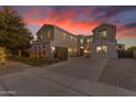 Two-story home with festive lights, landscaping, and a long driveway at 3121 E Powell Way, Gilbert, AZ 85298