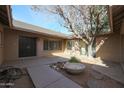 Private courtyard with mature tree and stone accents at 4901 W Augusta Cir, Glendale, AZ 85308