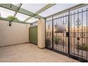 Gated courtyard with a pergola and access to the interior of the home at 524 S Allred Dr, Tempe, AZ 85288