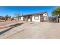 House exterior with a gated driveway and landscaping at 8840 W Desert Cove Ave, Peoria, AZ 85345