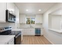 Bright kitchen, white cabinets, stainless steel appliances at 10754 W Hope Dr, Sun City, AZ 85351