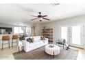 Bright living room with white couch and large windows at 12543 W Estero Ln, Litchfield Park, AZ 85340