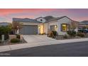 Beautiful stucco home with a 2-car garage, landscaping, and a mountain view at 16573 W Valencia Dr, Goodyear, AZ 85338