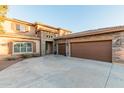 Two-story house with stone accents and a three-car garage at 26529 N 167Th Ave, Surprise, AZ 85387