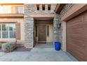 Front entrance with decorative door and stonework at 26529 N 167Th Ave, Surprise, AZ 85387