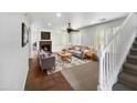 Spacious living room with fireplace, tiled floor, and neutral decor at 4319 E Vaughn Ave, Gilbert, AZ 85234