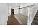 Bright living room featuring a fireplace and staircase at 4319 E Vaughn Ave, Gilbert, AZ 85234