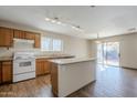 Kitchen with granite countertops, wooden cabinets, and an island at 555 W Racine Loop, Casa Grande, AZ 85122