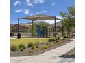 Community playground with shaded seating and play structures at 2846 W Thurman Dr, Laveen, AZ 85339