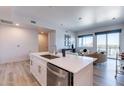 Modern kitchen island with white cabinets and stainless steel appliances at 3131 N Central Ave # 6014, Phoenix, AZ 85012