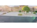 Front view of house with two-car garage and a tree at 4202 E Broadway Rd # 132, Mesa, AZ 85206