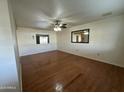 Bright living room with hardwood floors and a ceiling fan at 5725 E Covina Rd, Mesa, AZ 85205