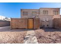 Tan two-story stucco building with a gated entrance and gravel landscaping at 600 S Dobson Rd # 75, Mesa, AZ 85202