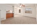 Spacious living room with carpeted floors and a ceiling fan at 600 S Dobson Rd # 75, Mesa, AZ 85202