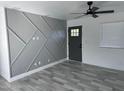 Open living area with gray accent wall and tile floors at 819 E Erie St, Chandler, AZ 85225