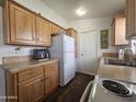 Kitchen with wood cabinets and white appliances at 8700 E University Dr # 545, Mesa, AZ 85207