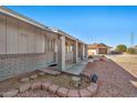 Brick home's front entrance with covered porch and landscaping at 11121 W Mirandy Ct, Sun City, AZ 85351