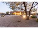 One-story home with desert landscaping and tree at dusk at 15405 E Cavedale Dr, Scottsdale, AZ 85262