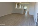 Bright and spacious living area with wood-look tile floors at 17065 W Seldon Ln, Waddell, AZ 85355