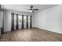 Bright living room with wood-look tile flooring and bay window at 17200 W Bell Rd # 511, Surprise, AZ 85374