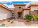 Front entry with stone facade and mature plants at 17667 N Estrella Vista Dr, Surprise, AZ 85374