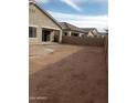 Backyard view of property with block wall and neighboring homes at 21039 E Poco Calle St, Queen Creek, AZ 85142