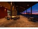 Outdoor seating area with fire pit and mountain views at sunset at 32962 N 131St Dr, Peoria, AZ 85383