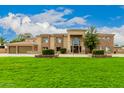 House exterior showcasing stone facade and a large yard at 8611 E Cholla St, Scottsdale, AZ 85260