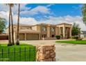 Impressive house exterior, showcasing stone accents and a manicured lawn at 8611 E Cholla St, Scottsdale, AZ 85260