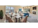 Elegant dining area with a marble table and four beige chairs at 11845 N 40Th Pl, Phoenix, AZ 85028