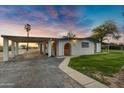 Front view of a remodeled midcentury modern home with carport at 11876 N Moore Rd, Valley Farms, AZ 85191