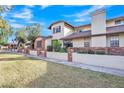 Row of two story homes with brick facade and manicured lawns at 170 E Guadalupe Rd # 180, Gilbert, AZ 85234