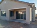 Covered patio with sliding glass doors and adjacent yard at 21024 E Poco Calle St, Queen Creek, AZ 85142