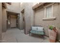 Inviting entryway with a bench and potted plants at 2121 W Tallgrass Trl # 126, Phoenix, AZ 85085