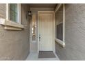 Light beige front door with sidelights and a small welcome mat at 2121 W Tallgrass Trl # 126, Phoenix, AZ 85085