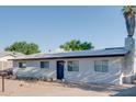 Ranch style home with gray exterior, stone accents, and a dark-colored front door at 217 E Bruce Ave, Gilbert, AZ 85234