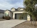 Charming house with a two-car garage and drought-tolerant landscaping at 37776 W San Ildefanso Ave, Maricopa, AZ 85138