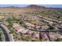 Aerial view of community with mountain views and golf course at 42414 N 46Th Ln, Phoenix, AZ 85086