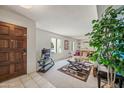 Entryway with tiled floor, wood door and view into living room at 6812 E Friess Dr, Scottsdale, AZ 85254