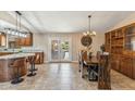 Dining area with a large wooden table and access to the backyard pool at 1045 E Cloud Rd, Phoenix, AZ 85086