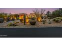 Desert landscape with three-car garage at dusk at 10542 E Skinner Dr, Scottsdale, AZ 85262