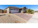 View of the home's exterior, including a brick driveway and sidewalk at 11980 S 173Rd Ave, Goodyear, AZ 85338