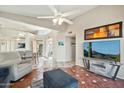 Spacious living room with tiled floors, comfy seating, and a large TV at 14444 W Moccasin Trl, Surprise, AZ 85374