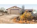 Front view of the home showcasing its garage and landscaping at 15612 S Tuthill Rd, Buckeye, AZ 85326